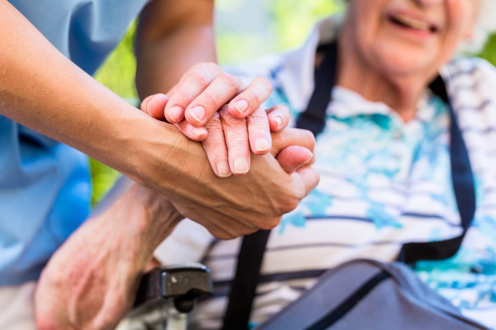 Skilled carer supporting someone with health needs in their own home